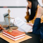 Male lawyer in the office with brass scale on wooden table. just